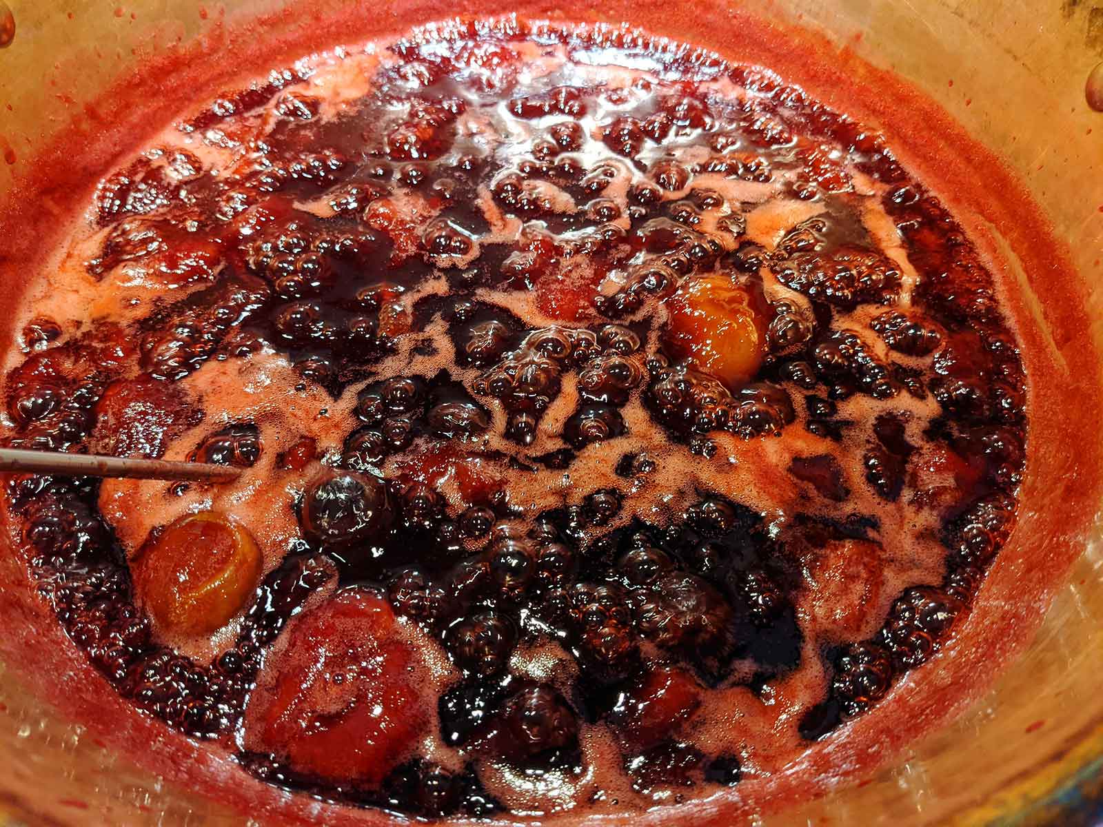 Plums cooking in a Copper Pan
