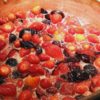 Strawberries and Pluots cooking in copper pan